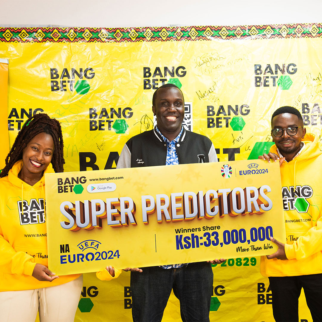 "Three people holding a Super Predictors banner at a Bang Bet event."