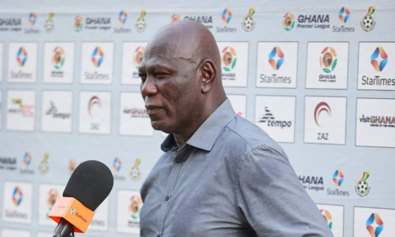 "Coach speaking during a press interview."