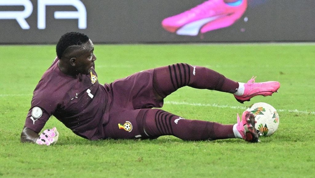 "Goalkeeper in action making a save on the field."