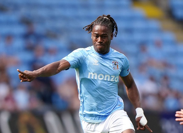 "Football player in action during a sunny match on the field."