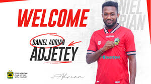 Daniel Adrian Adjetey unveiled as a new player for Asante Kotoko, wearing the team jersey and posing in front of a welcome banner