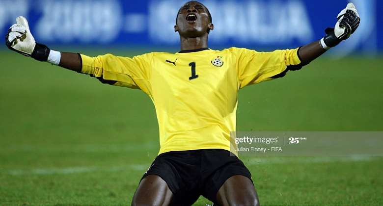 Goalkeeper celebrating on the field with arms stretched out."