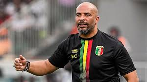 Coach wearing a Mali national team jersey during a match.