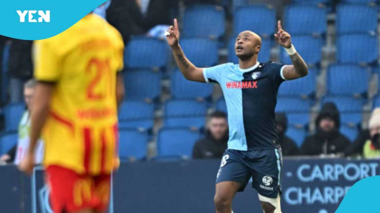 "Andre Ayew celebrating a goal with arms raised."