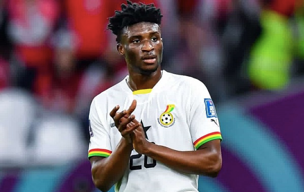 "Mohammed Kudus in Ghana national team jersey applauding during a match."