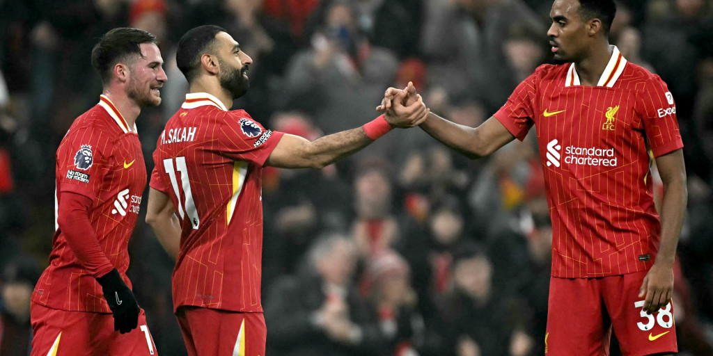 Liverpool players celebrating with a handshake.