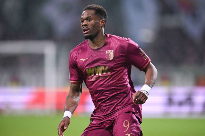 "Football player in maroon jersey during a match."