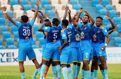 Nations FC players celebrating together during a match.