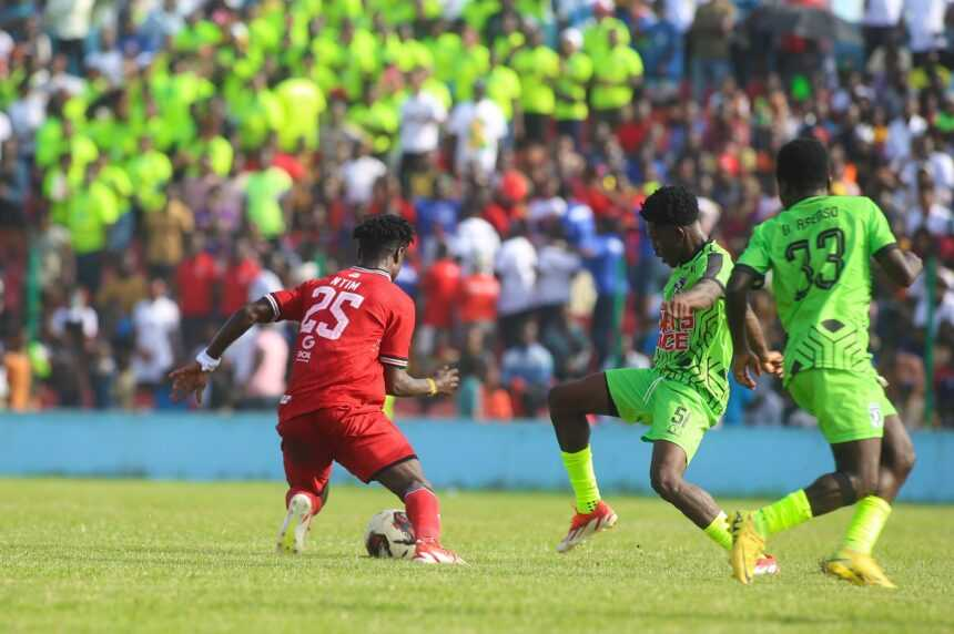 Heart of Lions and Nations FC players contesting for the ball during a competitive match