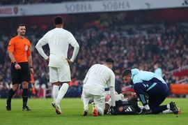 "Arsenal player receiving medical attention during a match"