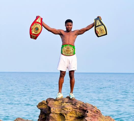 Sampson Segbedzi proudly showcasing his championship belts.