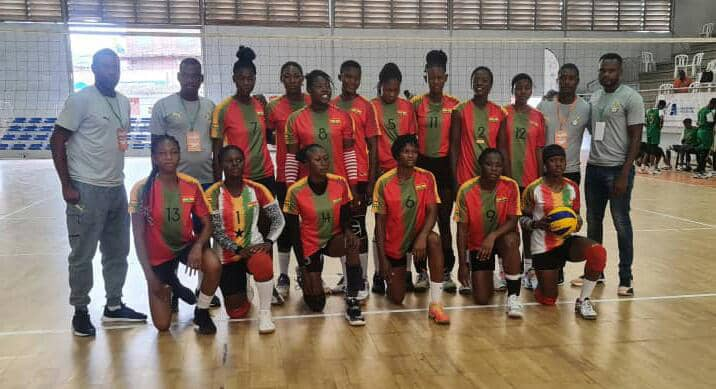 "Women's volleyball team posing for a group photo."