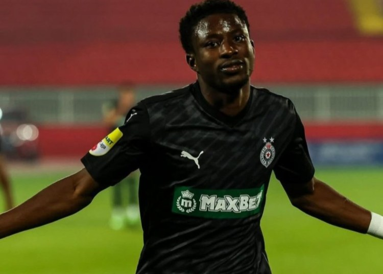 Zubairu Ibrahim celebrating a goal in a Partizan Belgrade jersey.