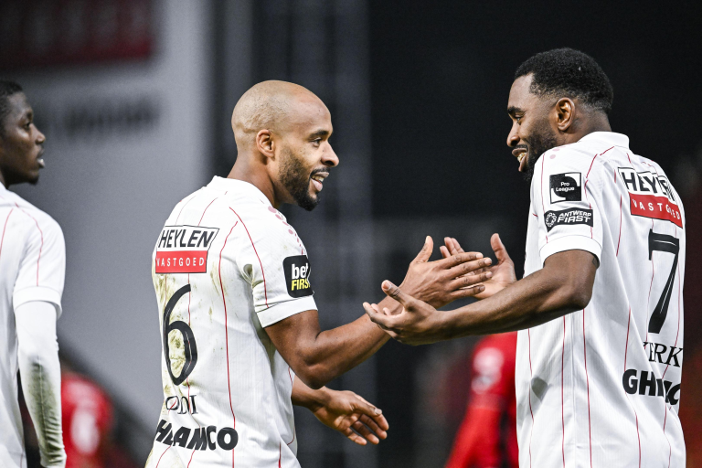 Denis Odoi celebrating with a teammate after scoring for Royal Antwerp.