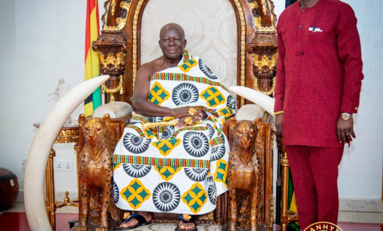 "Otumfuo Osei Tutu II seated on a traditional golden throne."