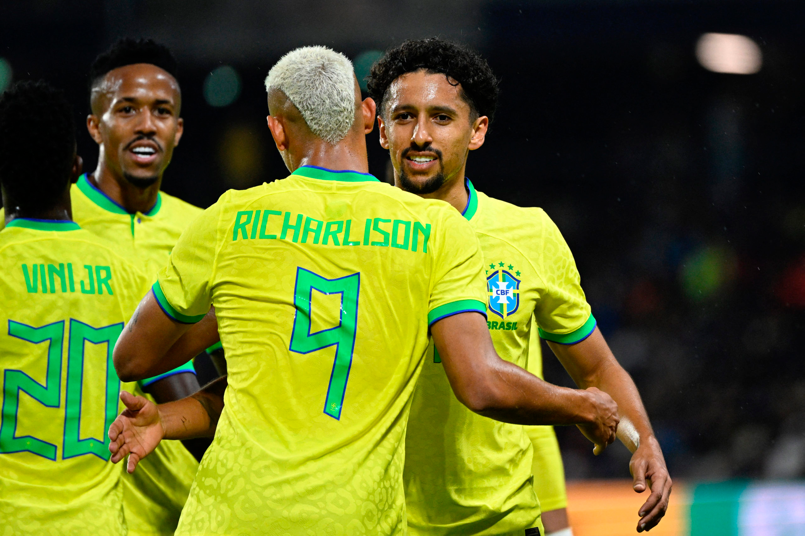 Brazilian football players celebrating, with Richarlison wearing the number 9 jersey.