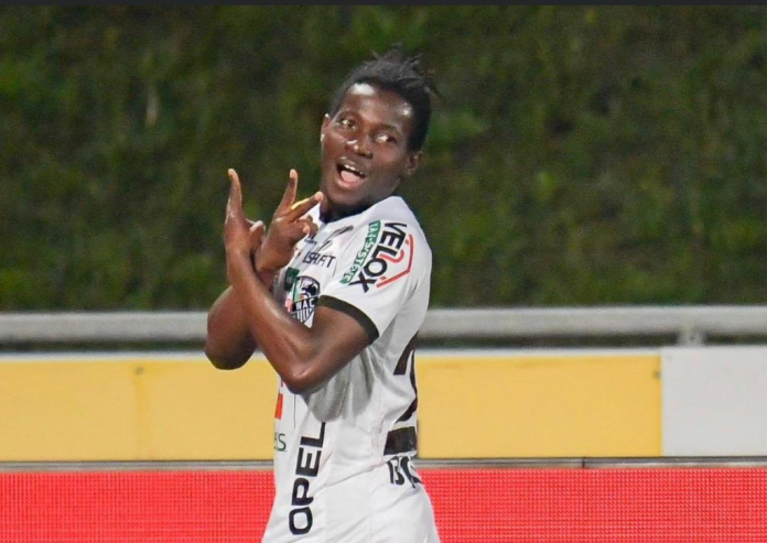 Footballer celebrating with a joyful gesture during a match.