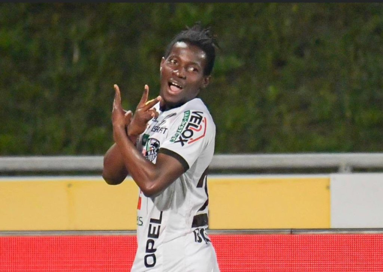 Footballer celebrating with a joyful gesture during a match.