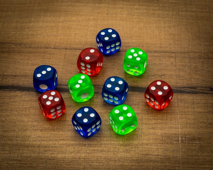 Colorful dices on wooden background