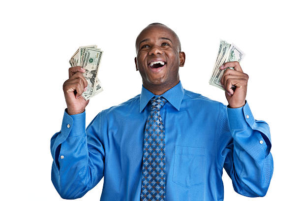 Successful happy man wearing a suit holding money
