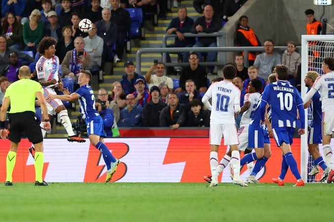 shambulizi-la-kichwa-crystal-palace-dhidi-ya-lech-poznan Mchezaji wa Crystal Palace akiruka juu kupiga mpira wa kichwa dhidi ya mabeki wa Lech Poznań langoni.