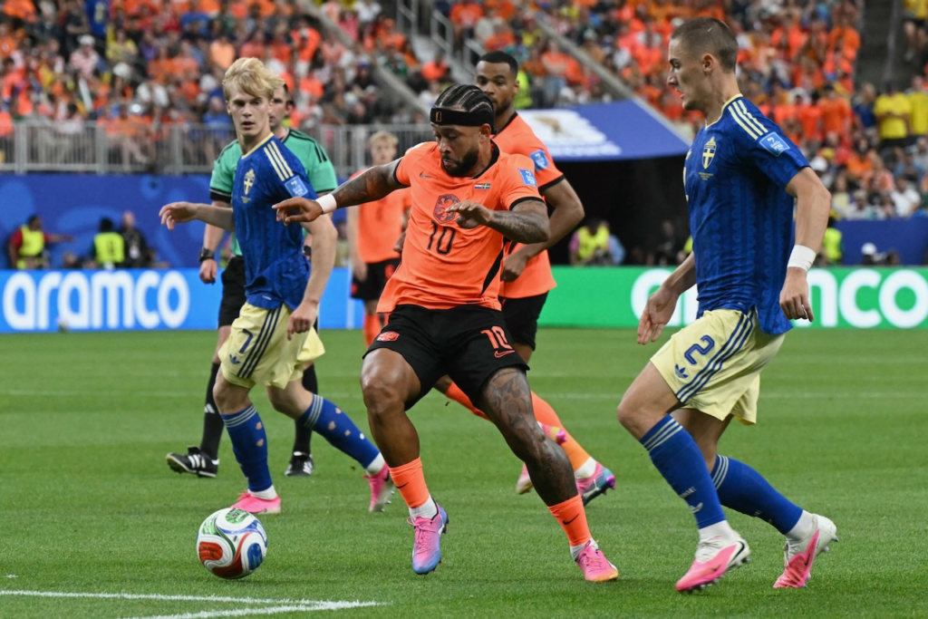 Netherlands and Sweden players battle for possession during a football match