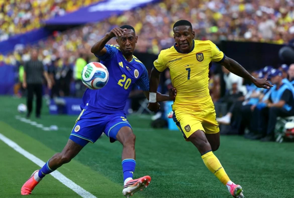 Ecuador striker shoots as Curacao goalkeeper makes a save