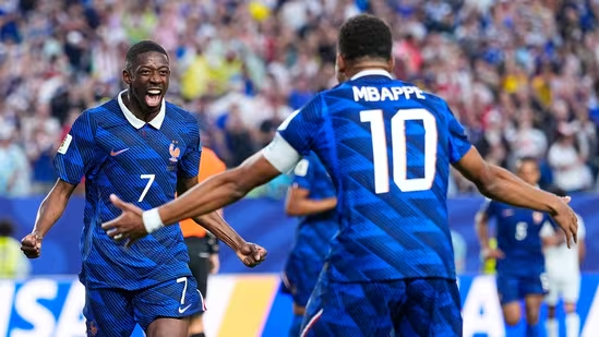 France football players celebrate a goal during an international match.