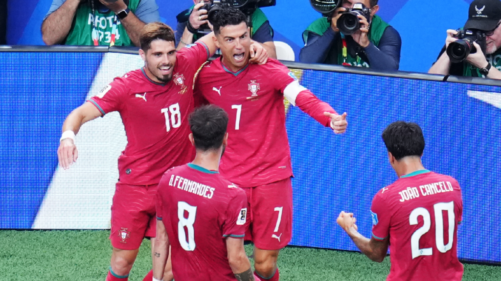 Portugal players celebrate after scoring a goal