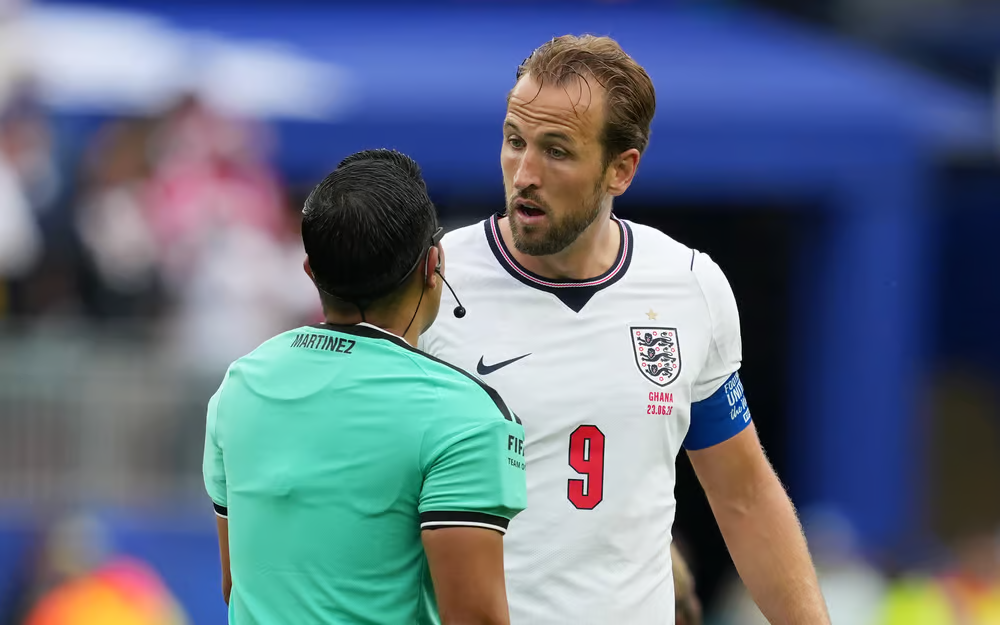 Harry Kane speaks with the referee during the game.