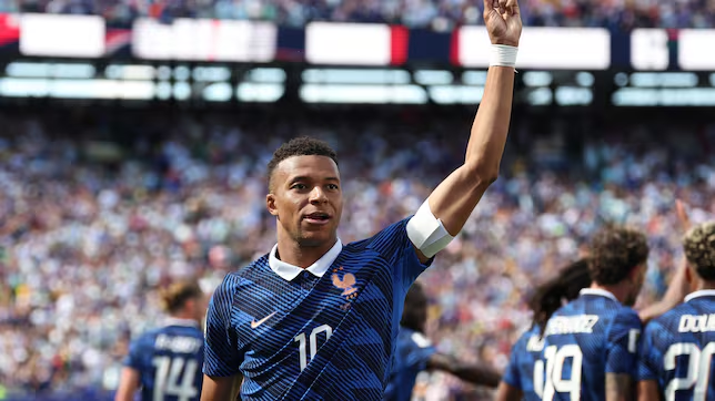 Kylian Mbappé is raising his hands in the ground