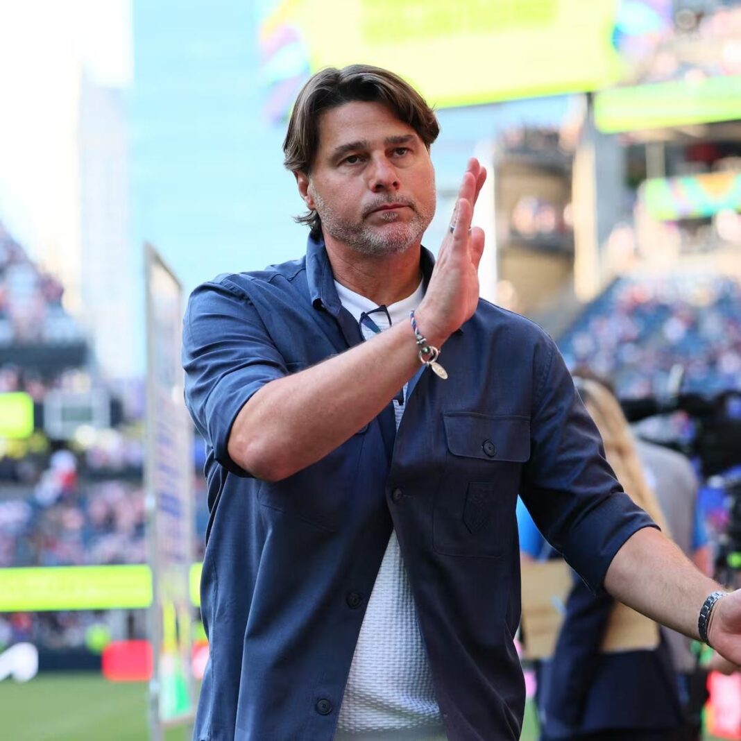 Mauricio Pochettino applauding on the touchline during a football match.