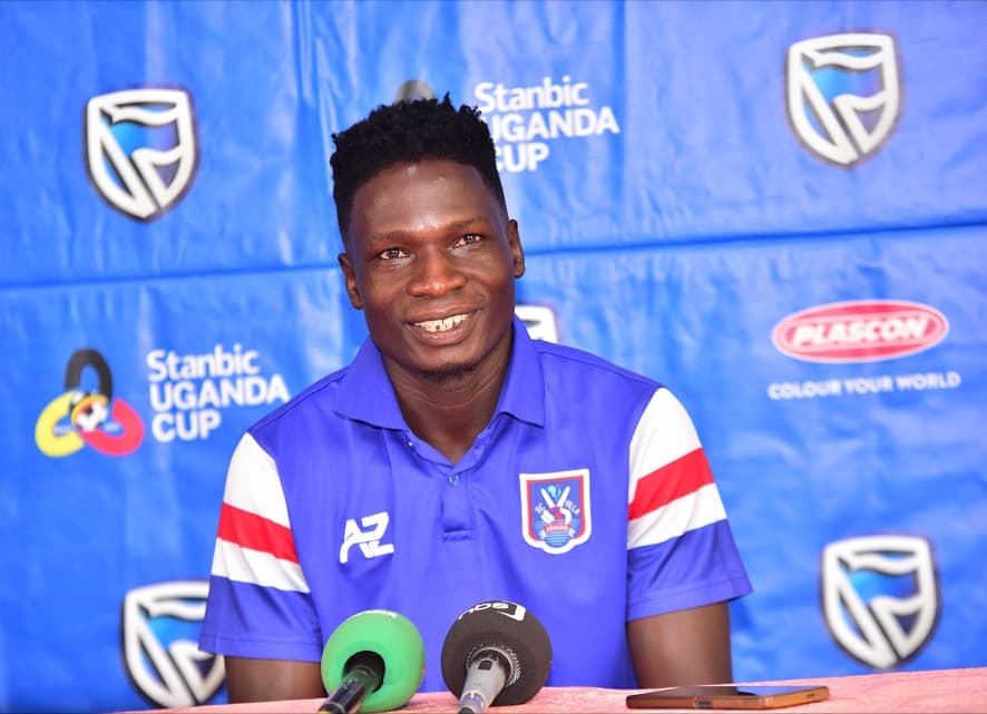David Owori, SC Villa captain, pictured during a press event wearing his team shirt in front of a Stanbic Uganda Cup backdrop.