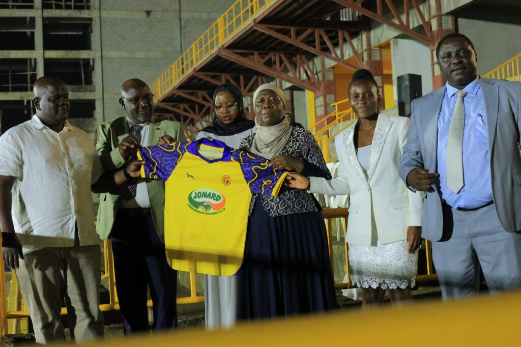 Officials display a yellow-and-purple KCCA Women FC jersey during the club launch.