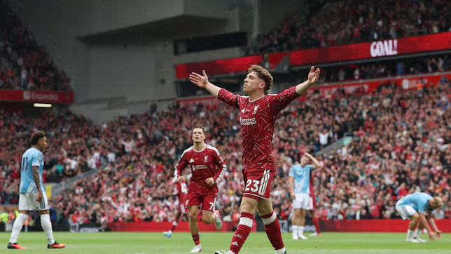 Liverpool winger Victor Muñoz celebrates with his arms raised after scoring against Nottingham Forest.
