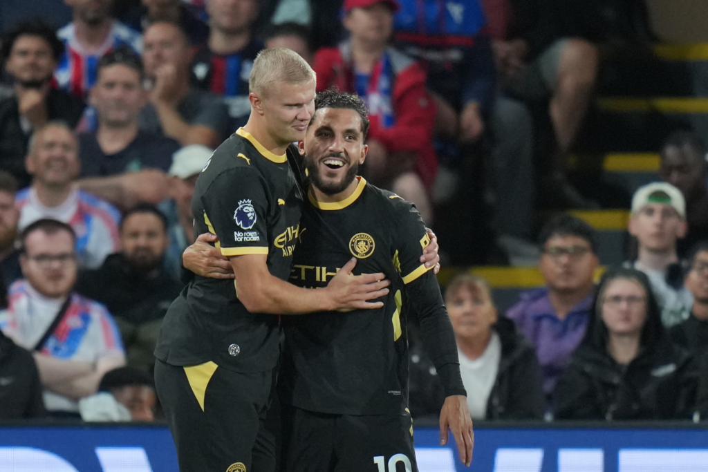 Manchester City forwards Erling Haaland and Rayan Cherki embrace after both scored twice against Crystal Palace.