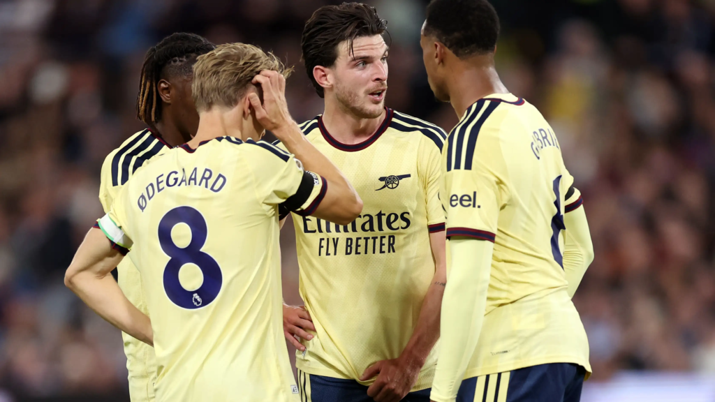 Declan Rice, Martin Ødegaard, Gabriel Magalhães and Eberechi Eze gather on the pitch during Aston Villa versus Arsenal.