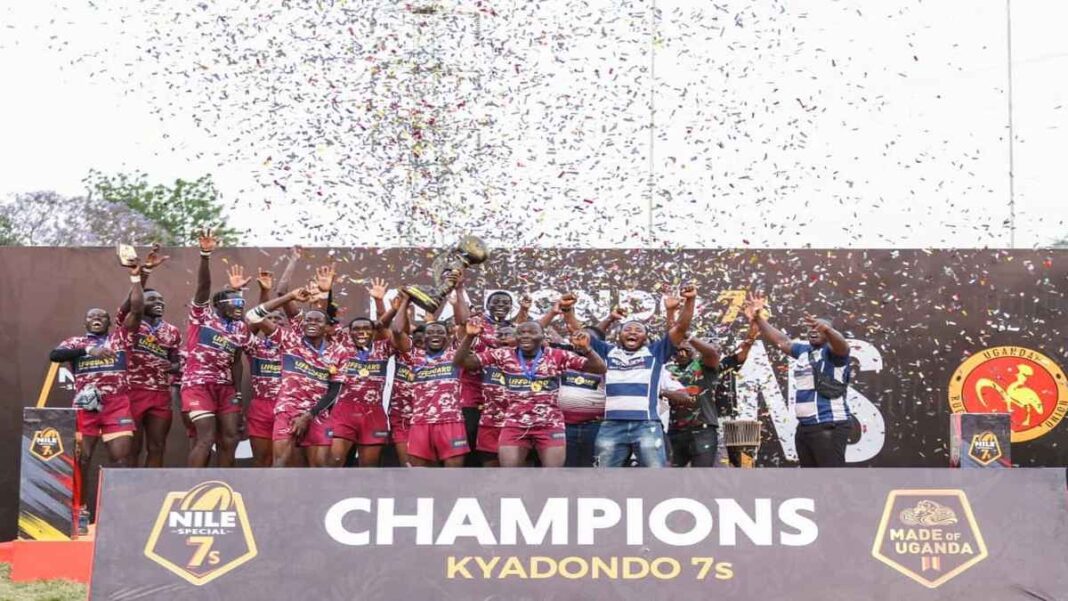Rams Rugby Club players lift the Kyadondo 7s trophy during celebrations after beating Platinum Credit Heathens in the 2026 final.
