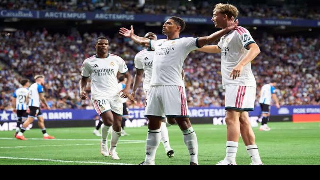 Jude Bellingham celebrates with arms outstretched after scoring for Real Madrid against Espanyol in a La Liga match.