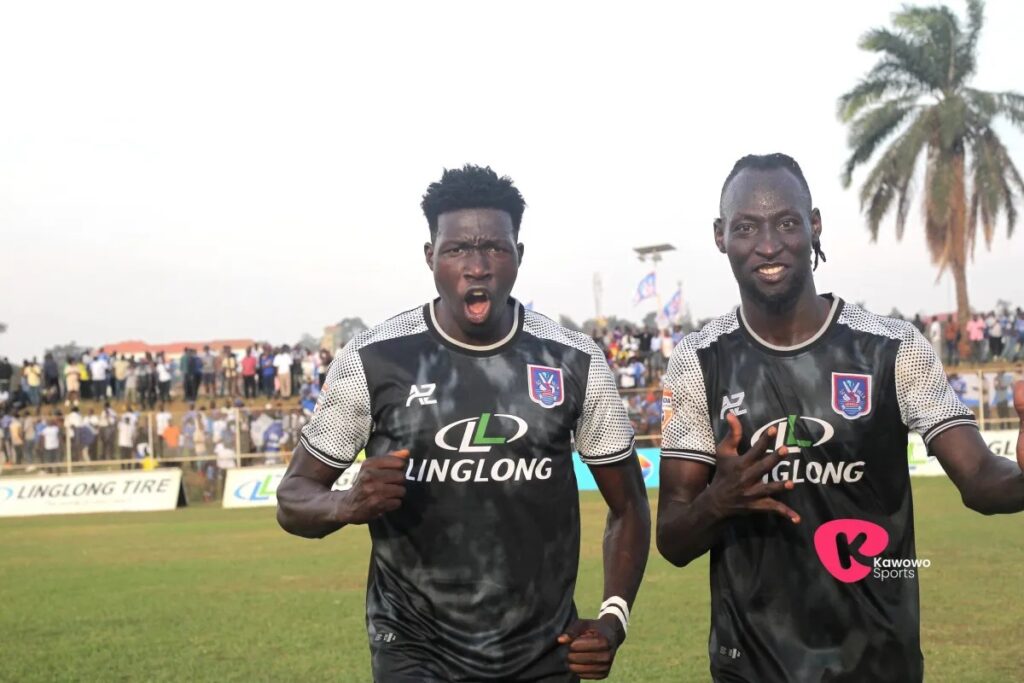 Two SC Villa players celebrate on the pitch following the Jogoos’ 2-0 Uganda Premier League victory over Express FC.