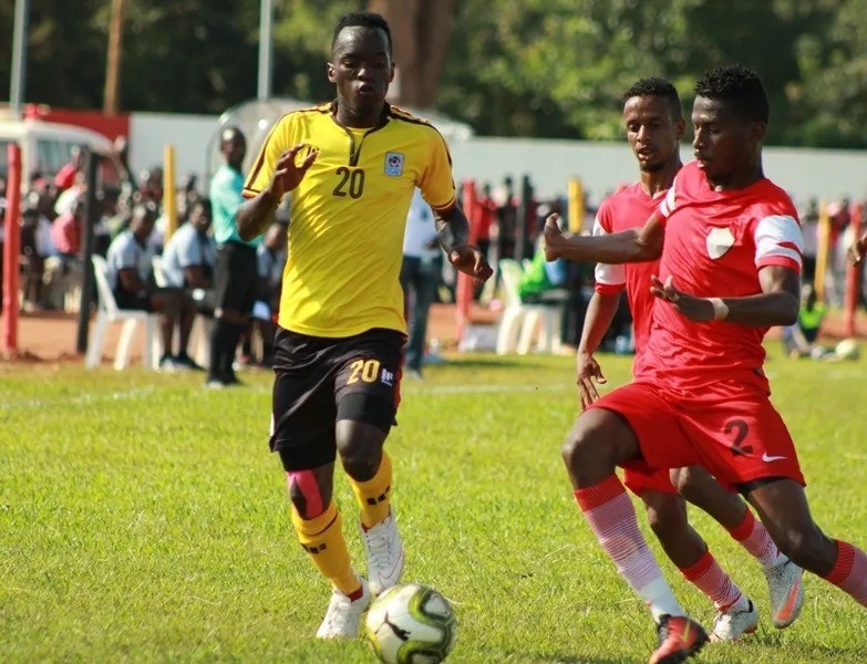 Uganda’s Saddam Masereka dribbles the ball against Sudan’s Ammar Mohamed Kannou and another player during a CECAFA U-20 match in Gulu City.