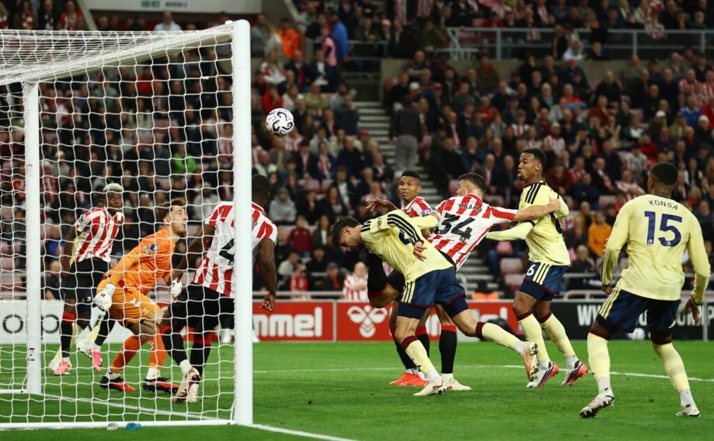 Arsenal and Sunderland players tussling for the ball inside the Sunderland penalty area during a tightly contested first half.