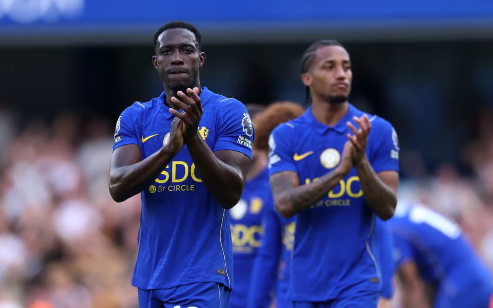 **Alt text:** Danny Welbeck and João Pedro of Chelsea applaud supporters after the match against Hull City, both wearing the blue home kit with "SDC by Circle" as the shirt sponsor.