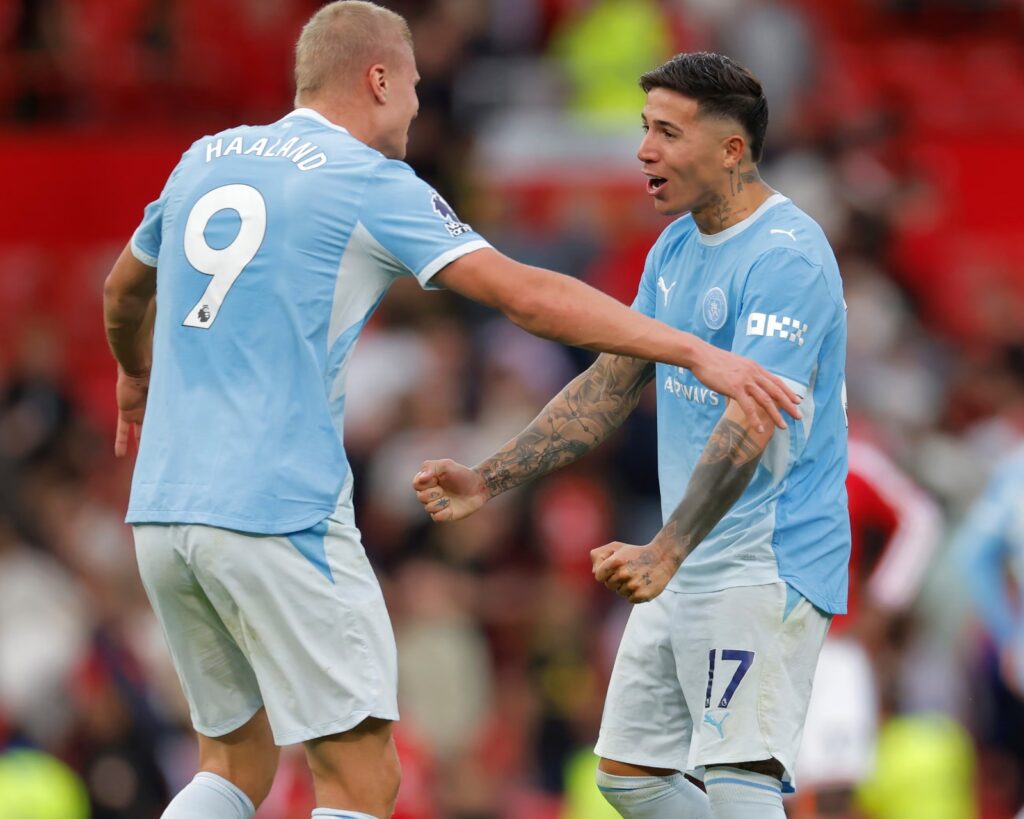 Erling Haaland and Enzo Fernández of Manchester City celebrating together on the pitch immediately after the final whistle.