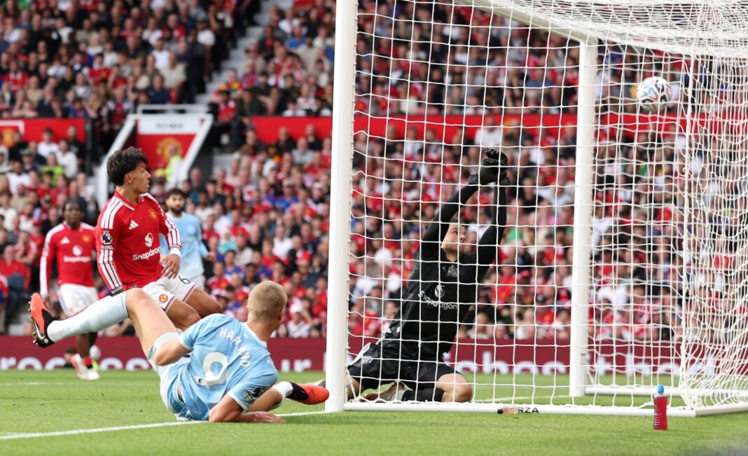**Alt text:** Erling Haaland of Manchester City scoring his team's first goal.