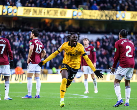 Wolves forward Mateus Mané runs with his arms outstretched while celebrating a goal against West Ham.