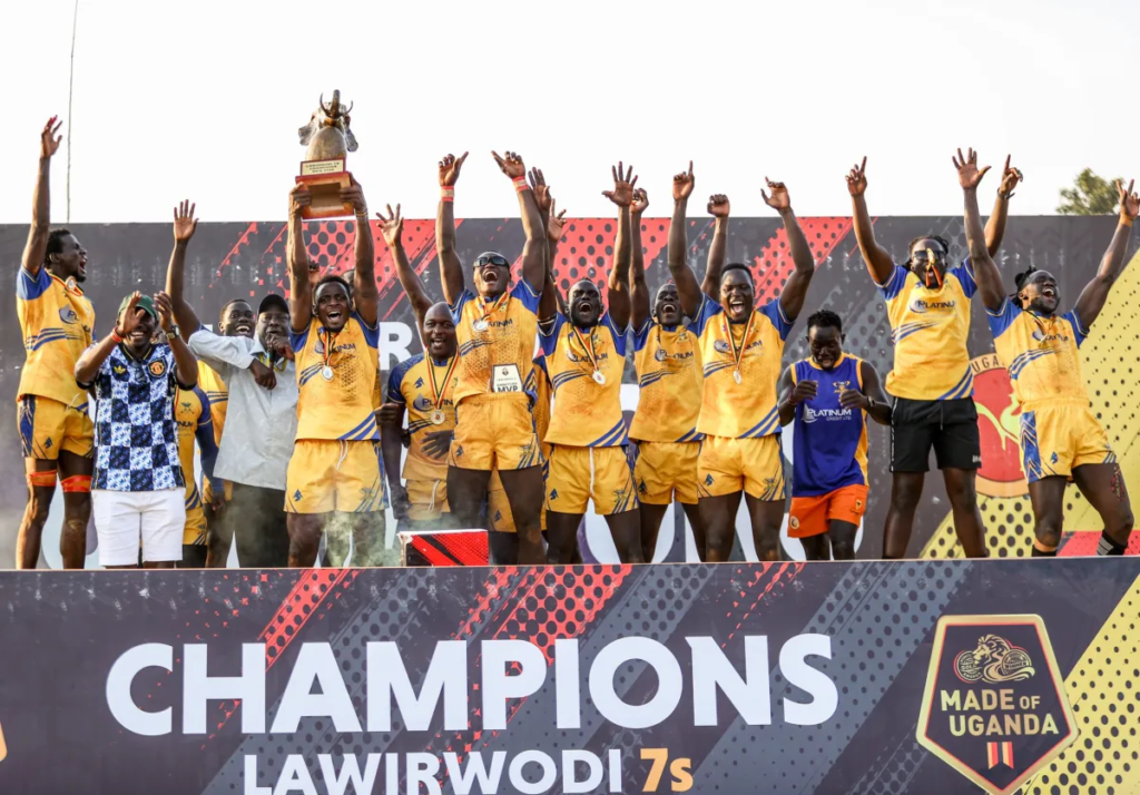 Heathens players wearing medals celebrate on the podium as they raise the 2026 Lawii Rwodi 7s men’s trophy.