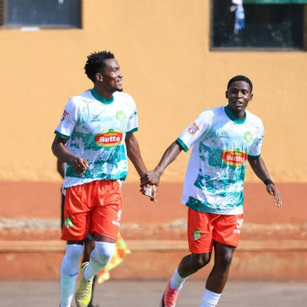Two BUL FC players hold hands while celebrating during the victory over Kataka FC at BCS Stadium.