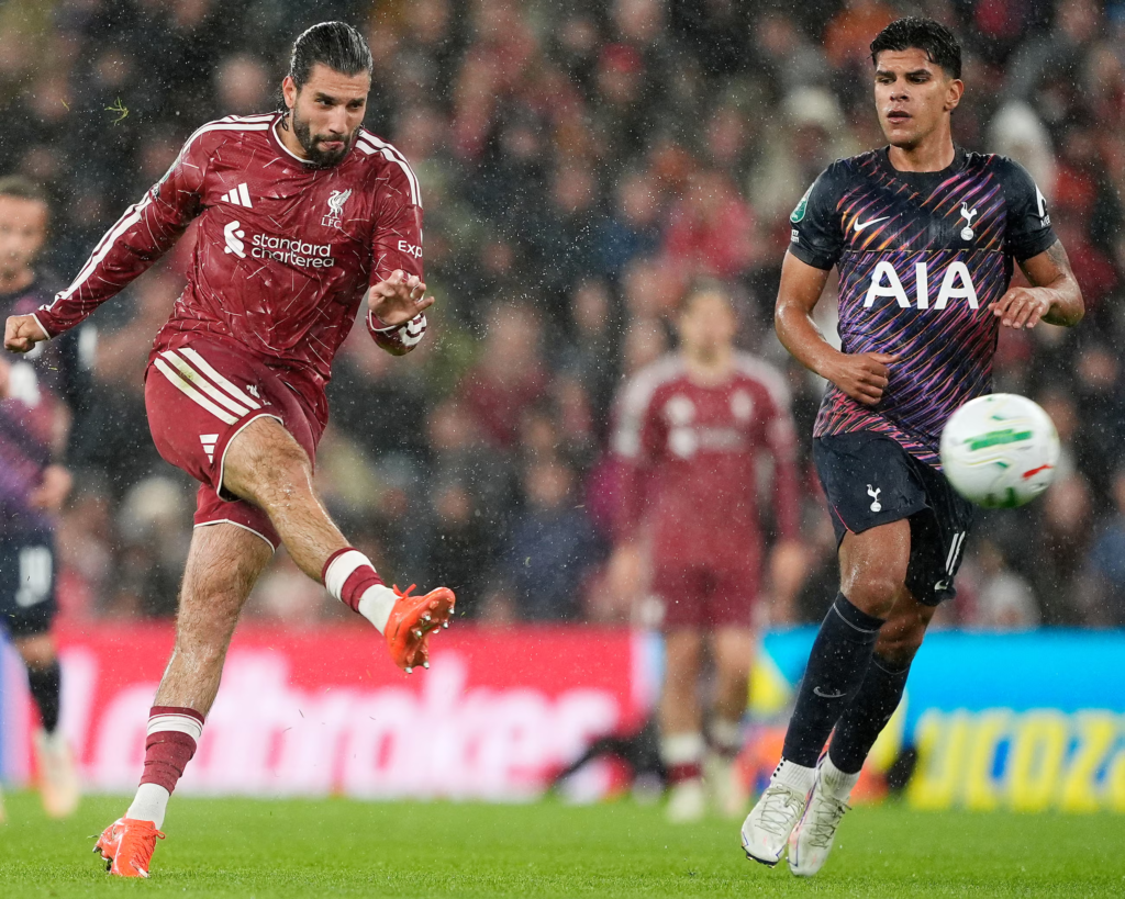 Liverpool midfielder Dominik Szoboszlai scores with a powerful swerving shot from outside the penalty area against Tottenham.