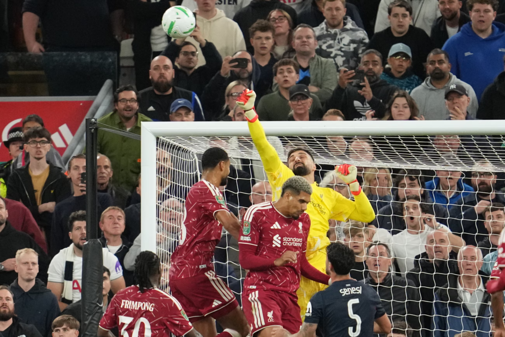 Liverpool goalkeeper Giorgi Mamardashvili jumps to punch the ball clear against Tottenham Hotspur.
